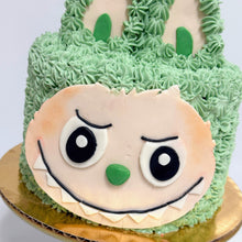 Load image into Gallery viewer, Cake designed to look like a Labubu character with green frosting and a face on a white background